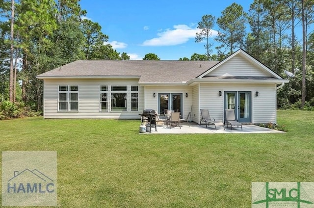 back of house featuring a yard and a patio