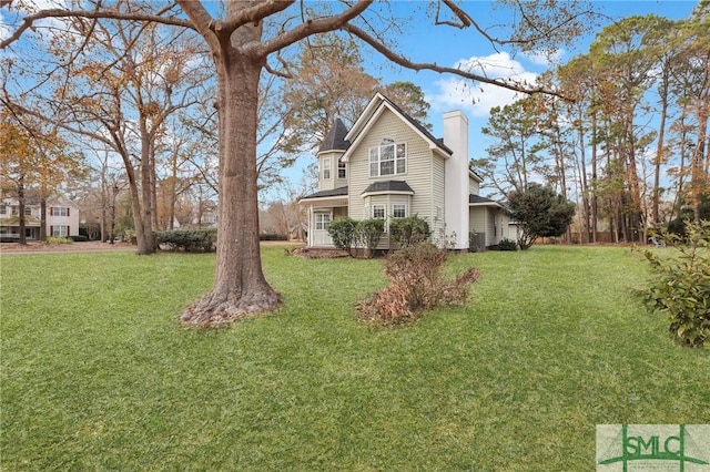 view of side of property with a yard