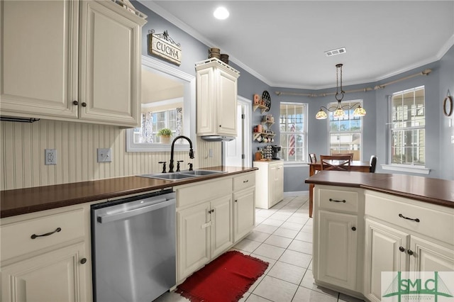 kitchen featuring pendant lighting, crown molding, dishwasher, and sink