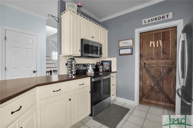 kitchen with ornamental molding, appliances with stainless steel finishes, and light tile patterned floors