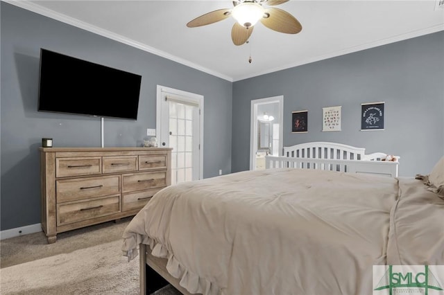 carpeted bedroom featuring crown molding, ensuite bath, and ceiling fan