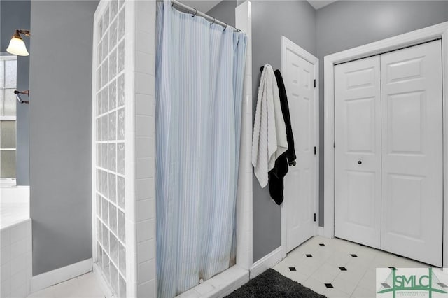 bathroom with tile patterned flooring and a shower with curtain