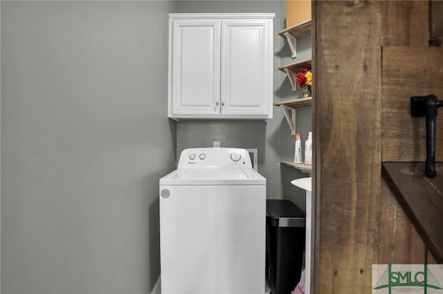 laundry room with washer / dryer and cabinets