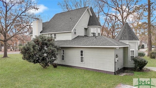 view of property exterior with a yard