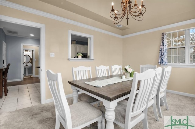 carpeted dining room with ornamental molding, sink, and a notable chandelier