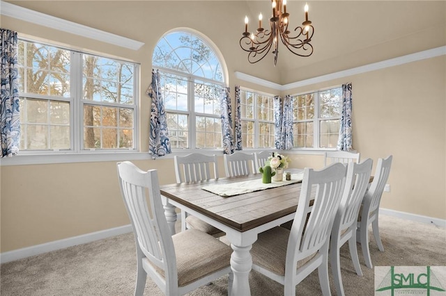 dining area with light carpet and a chandelier