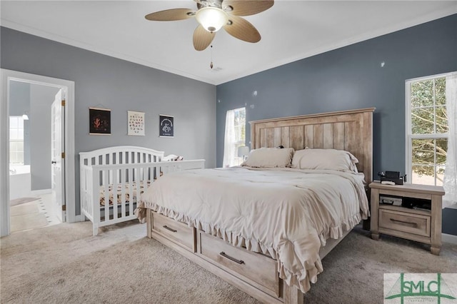 carpeted bedroom featuring crown molding and ceiling fan