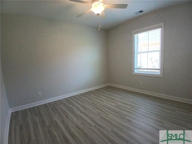 spare room featuring ceiling fan and dark hardwood / wood-style flooring