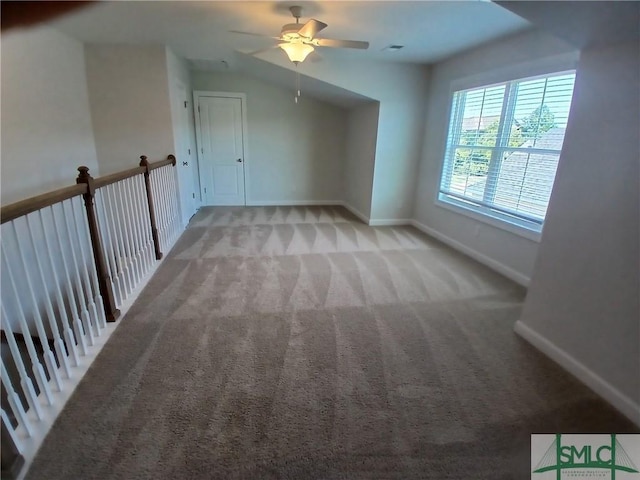 additional living space featuring light carpet, lofted ceiling, and ceiling fan