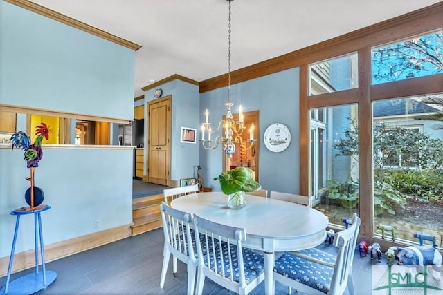 dining space with crown molding and a chandelier