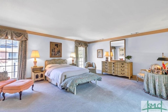 bedroom with ornamental molding and carpet floors