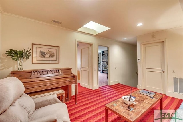 carpeted living room featuring a skylight and ornamental molding