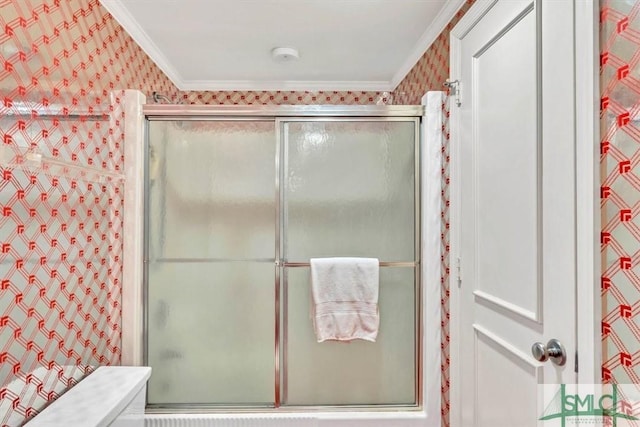 bathroom with a shower with door and ornamental molding