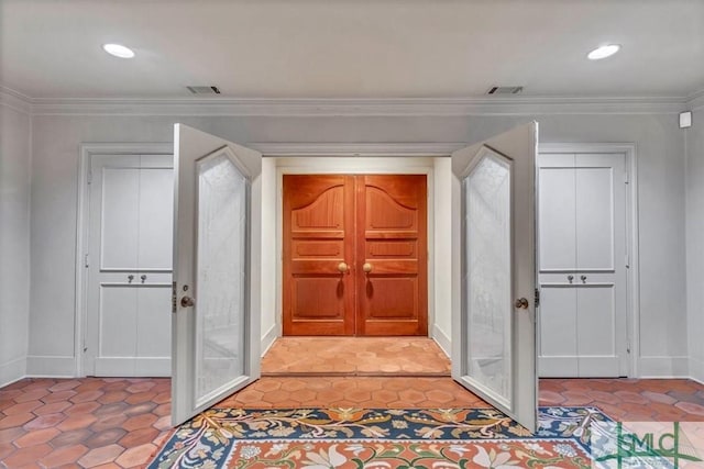 entryway with light tile patterned floors, ornamental molding, and french doors