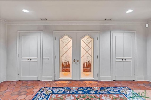 doorway to outside with crown molding, tile patterned floors, and french doors