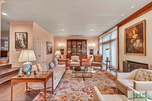 living room with ornamental molding and light hardwood / wood-style floors