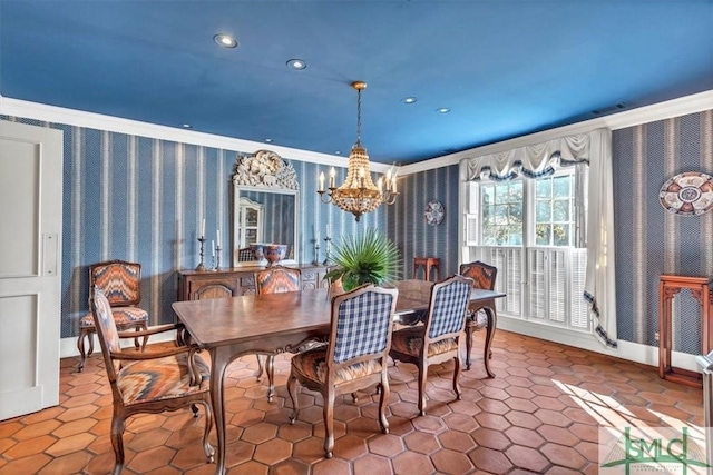 dining space with ornamental molding and a chandelier