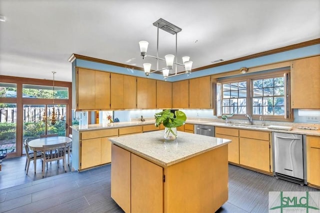 kitchen with a center island, sink, hanging light fixtures, and a notable chandelier