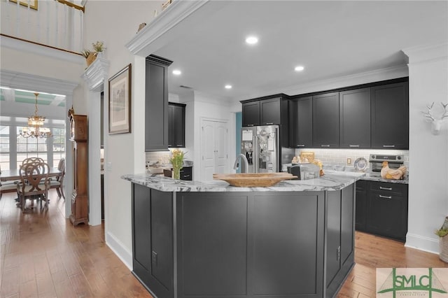 kitchen featuring crown molding, light stone counters, stainless steel fridge with ice dispenser, a chandelier, and light wood-type flooring