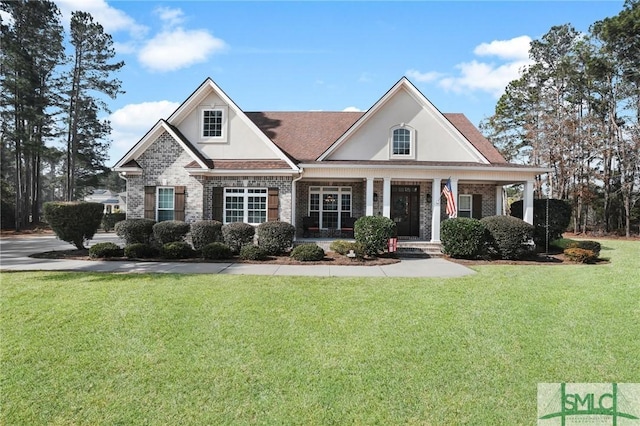 view of front facade with a front yard and covered porch