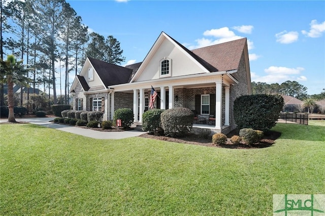 view of front of property featuring a front yard and covered porch