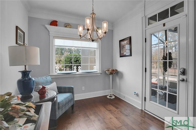 sitting room with dark hardwood / wood-style flooring, crown molding, and a wealth of natural light