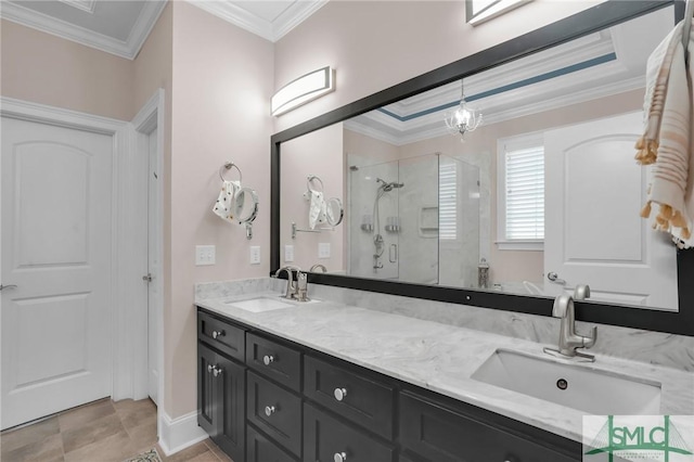 bathroom with ornamental molding, a shower with shower door, and vanity