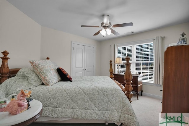 carpeted bedroom featuring ceiling fan and a closet