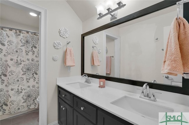 bathroom featuring tile patterned flooring, vanity, and toilet