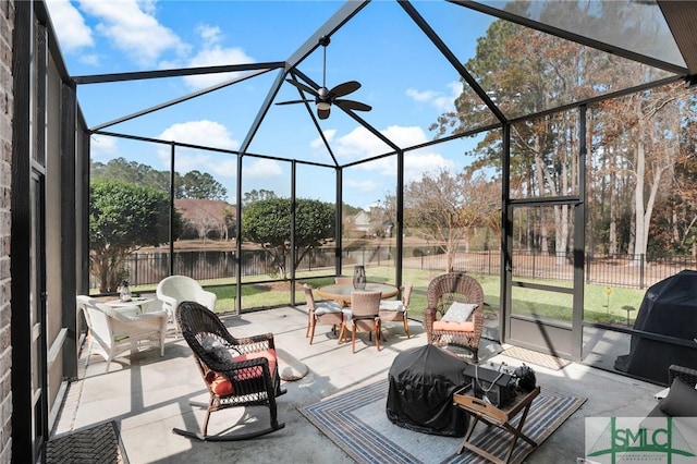 view of patio / terrace with a grill and glass enclosure