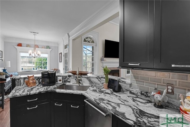 kitchen with sink, crown molding, dishwasher, light stone countertops, and kitchen peninsula