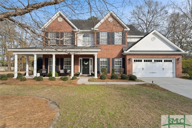 view of front of property featuring a porch, a garage, and a front lawn