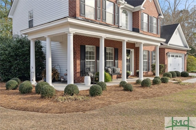 exterior space with a garage and covered porch