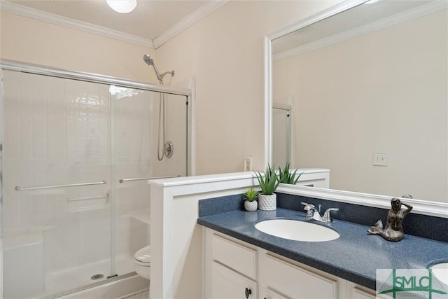 bathroom with a shower with door, crown molding, vanity, and toilet