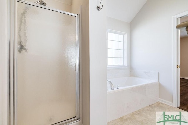 bathroom featuring vaulted ceiling, tile patterned floors, and independent shower and bath