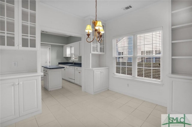 kitchen with sink, dishwasher, white cabinets, decorative light fixtures, and a chandelier