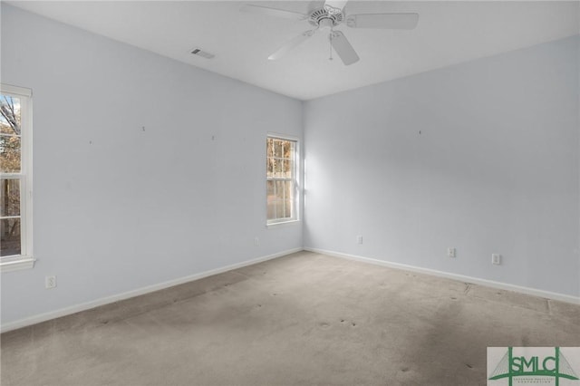 empty room featuring ceiling fan and carpet flooring