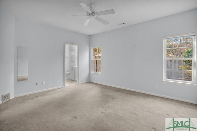 carpeted empty room featuring plenty of natural light and ceiling fan