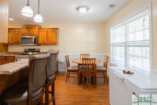 164 Glynn Ct, Hinesville, GA 31313 - kitchen with pendant lighting, hardwood / wood-style flooring, and stainless steel appliances