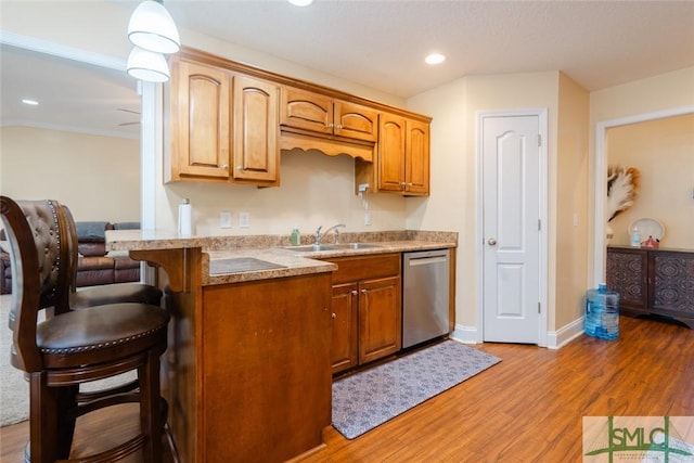 164 Glynn Ct, Hinesville, GA 31313 - kitchen with sink, light hardwood / wood-style flooring, a kitchen breakfast bar, kitchen peninsula, and dishwasher