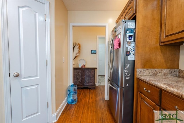 164 Glynn Ct, Hinesville, GA 31313 - kitchen with dark wood-type flooring, stainless steel fridge, and light stone countertops