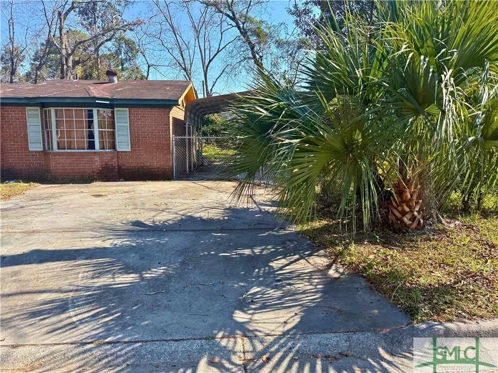 view of side of property featuring a carport