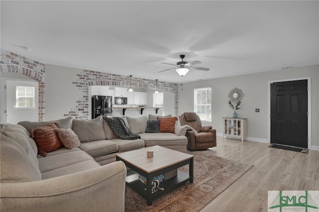 living room featuring light hardwood / wood-style floors and ceiling fan