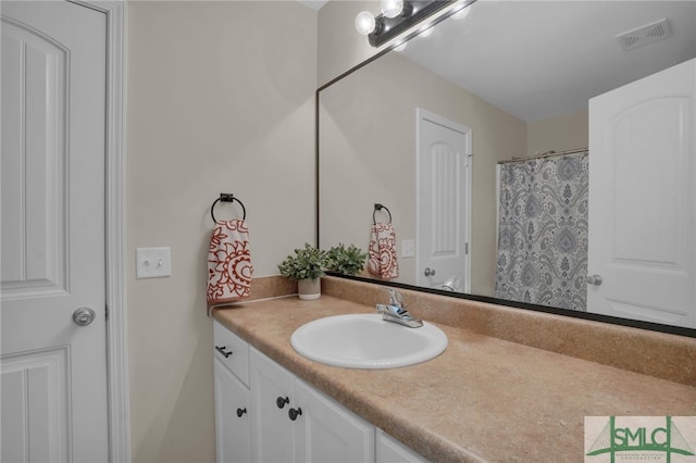 bathroom with vanity and curtained shower