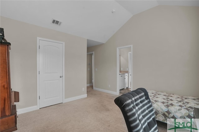 carpeted bedroom with lofted ceiling