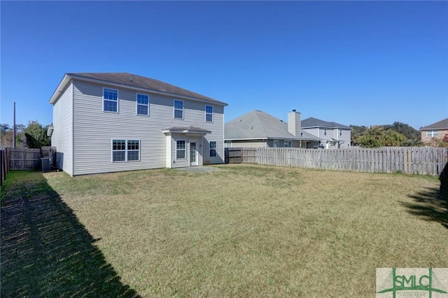 rear view of house featuring a yard and cooling unit