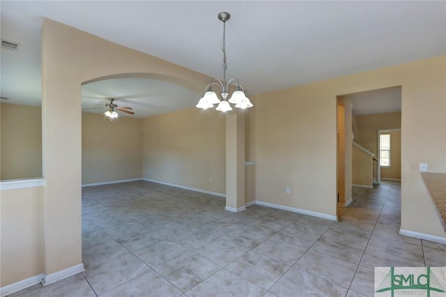 unfurnished room with ceiling fan with notable chandelier and light tile patterned floors