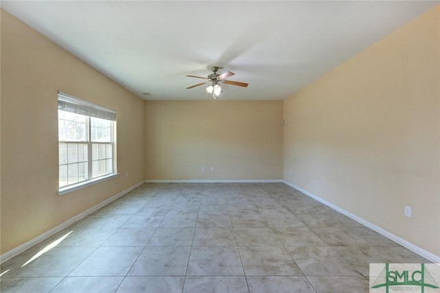 spare room featuring light tile patterned floors and ceiling fan