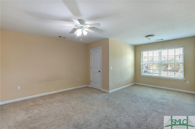 carpeted empty room featuring ceiling fan