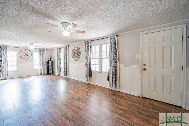 foyer featuring ceiling fan, dark hardwood / wood-style flooring, and a textured ceiling